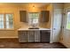Well-lit kitchen featuring gray cabinets, stainless steel appliances, and a view from over the sink at 1204 Amberstone Dr, Knightdale, NC 27545