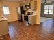 Full kitchen with stainless steel appliances, gray cabinets, breakfast area with view to a bright living room at 1204 Amberstone Dr, Knightdale, NC 27545