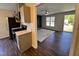 Living room and kitchen of home featuring hardwood floors and a stainless steel refrigerator at 1204 Amberstone Dr, Knightdale, NC 27545
