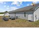 Backyard with vinyl siding, small patio, and satellite dish at 123 Ariel St, Lillington, NC 27546