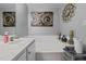 Bright bathroom features a soaking tub, neutral walls, and decorative art at 123 Ariel St, Lillington, NC 27546