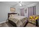 Comfortable bedroom with hardwood floors, ceiling fan, and an upholstered headboard at 123 Ariel St, Lillington, NC 27546