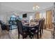 Open concept dining area featuring a large table with seating adjacent to a living room with vaulted ceilings at 123 Ariel St, Lillington, NC 27546