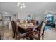 Open-concept dining area with elegant table setting, adjacent to the living room and kitchen at 123 Ariel St, Lillington, NC 27546
