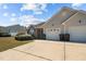 Charming home featuring a brick facade, grey siding, well-kept landscaping, and a two-car garage at 123 Ariel St, Lillington, NC 27546