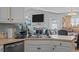 Kitchen with a double sink and view of the fireplace and dining area at 123 Ariel St, Lillington, NC 27546