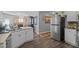 Bright kitchen with stainless steel refrigerator and wooden floors at 123 Ariel St, Lillington, NC 27546