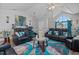Stylish living room featuring comfortable black leather couches, a unique rug, and a bright, airy atmosphere at 123 Ariel St, Lillington, NC 27546