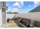 Outdoor patio with wicker furniture and a white fence offers a private retreat at 123 Ariel St, Lillington, NC 27546