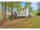 Exterior view of house with wooden deck near an abundance of flowers at 147 W Alex Dr, Clayton, NC 27520