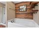 Relaxing bathroom featuring a soaking tub, a shower, and wood paneling at 147 W Alex Dr, Clayton, NC 27520