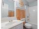 Well-lit bathroom with modern fixtures, including a vanity, toilet, and shower-tub combo at 147 W Alex Dr, Clayton, NC 27520