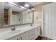 Bathroom featuring a double vanity with white cabinetry and a large mirror at 147 W Alex Dr, Clayton, NC 27520