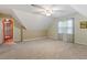 Spacious bonus room with neutral carpet, ceiling fan, and plenty of natural light, perfect for versatile living at 147 W Alex Dr, Clayton, NC 27520