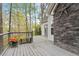 Outdoor deck featuring stone accent wall and metal railing at 147 W Alex Dr, Clayton, NC 27520