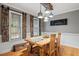The dining room includes a large wooden table, rustic light fixtures, and wood accent shutters at 147 W Alex Dr, Clayton, NC 27520