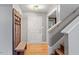 Hallway with wood floors, staircase, bench and coat rack at 147 W Alex Dr, Clayton, NC 27520
