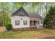 Charming two-story home featuring red shutters, covered porch and lush, mature landscaping at 147 W Alex Dr, Clayton, NC 27520