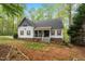 Charming two-story home featuring red shutters, covered porch and lush, mature landscaping at 147 W Alex Dr, Clayton, NC 27520