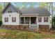 Charming two-story home featuring red shutters, covered porch and lush, mature landscaping at 147 W Alex Dr, Clayton, NC 27520