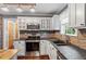 Charming kitchen with stone backsplash, wooden island, and updated appliances, combining rustic and modern design elements at 147 W Alex Dr, Clayton, NC 27520