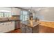 Open kitchen layout with views to the living area, perfect for entertaining, featuring stone accents and natural light at 147 W Alex Dr, Clayton, NC 27520