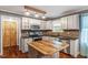 Well-appointed kitchen with stone backsplash, wood-accented island, and stainless appliances providing a modern cooking space at 147 W Alex Dr, Clayton, NC 27520