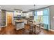 Stylish kitchen featuring white cabinets, stone accents, stainless steel appliances, and a breakfast nook creating a warm ambiance at 147 W Alex Dr, Clayton, NC 27520