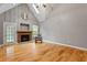 Bright living room featuring a cozy stone fireplace and expansive hardwood flooring, perfect for gatherings at 147 W Alex Dr, Clayton, NC 27520