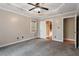 Spacious carpeted bedroom offering lots of natural light and a view into the en suite bath at 147 W Alex Dr, Clayton, NC 27520