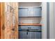 A rustic pantry features custom wooden doors and drawers, creating a functional and stylish storage space at 147 W Alex Dr, Clayton, NC 27520