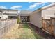 A view of the backyard with a wooden fence, grassy area, and access to a screened porch at 149 Logbridge Rd, Chapel Hill, NC 27516