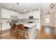 Modern kitchen featuring white cabinets, stainless steel appliances, and a marble-top kitchen island with seating at 149 Logbridge Rd, Chapel Hill, NC 27516
