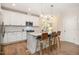 Modern kitchen featuring white cabinets, stainless steel appliances, and a marble-top kitchen island with seating at 149 Logbridge Rd, Chapel Hill, NC 27516