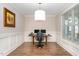 Bright office with a modern light fixture, wainscotting and wood floors at 149 Logbridge Rd, Chapel Hill, NC 27516