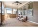 Relaxing screened porch featuring wood flooring, comfortable seating, and ample natural light at 149 Logbridge Rd, Chapel Hill, NC 27516