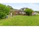 Expansive backyard featuring a detached garage, mature trees and an enclosed area at 1500 Antioch Rd, Rocky Mount, NC 27801