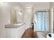 Bathroom with double sink vanity, large mirror, and shower with blue patterned curtain at 1500 Antioch Rd, Rocky Mount, NC 27801