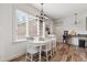 Sunlit dining area with white table and chairs and large windows overlooking the backyard at 1500 Antioch Rd, Rocky Mount, NC 27801