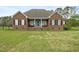 Welcoming brick home with a covered porch and ample green space at 1500 Antioch Rd, Rocky Mount, NC 27801