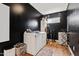 Well-lit laundry room with modern washer and dryer on hardwood floors with dark walls at 1500 Antioch Rd, Rocky Mount, NC 27801