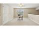 Neutral-toned bedroom with a desk and chair near a window, offering a bright and versatile space at 1515 Poets Glade Dr, Apex, NC 27523