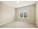 Neutral bedroom with a window overlooking the outdoor scenery at 1515 Poets Glade Dr, Apex, NC 27523