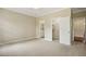 Large bedroom featuring neutral carpet, a ceiling fan, and access to an ensuite bathroom and walk-in closet at 1515 Poets Glade Dr, Apex, NC 27523