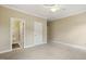 Spacious bedroom with neutral carpet, a ceiling fan, access to an ensuite bathroom, and lots of natural light at 1515 Poets Glade Dr, Apex, NC 27523