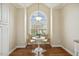 Cozy breakfast nook featuring hardwood floors, a modern light fixture, and a large arched window at 1515 Poets Glade Dr, Apex, NC 27523