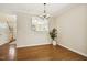 Dining space showcases hardwood floors, chandelier, and a clear view into the kitchen area at 1515 Poets Glade Dr, Apex, NC 27523