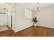 Elegant dining area featuring hardwood floors, chandelier, and an adjacent pass-through to the kitchen at 1515 Poets Glade Dr, Apex, NC 27523