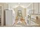 Eat in kitchen with a large window and white cabinetry at 1515 Poets Glade Dr, Apex, NC 27523