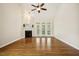 Bright living room features hardwood floors, fireplace, and large windows at 1515 Poets Glade Dr, Apex, NC 27523